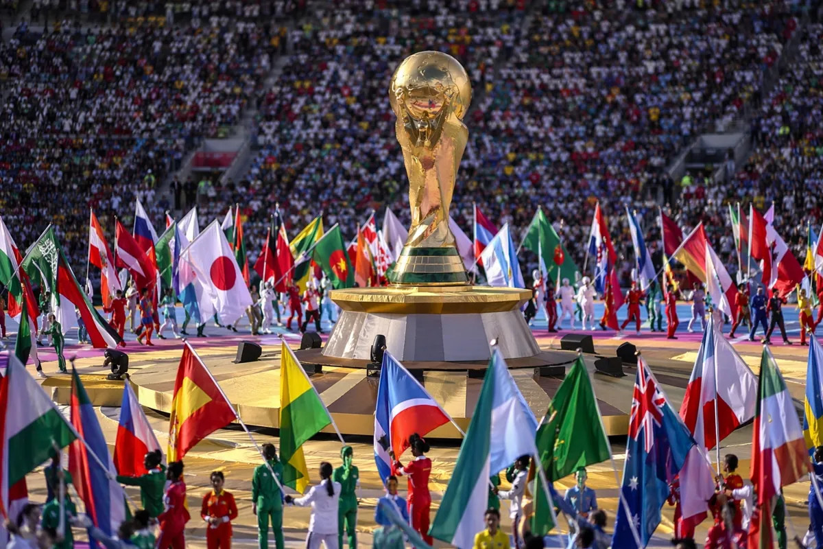 Wide shot of vibrant World Cup opening ceremony rehearsal, colorful flags of various natio